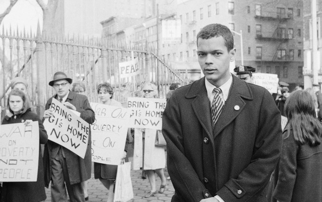 Julian Bond of Georgia, 26, watches as people stream into the St. Mark's Church-on-the-Bouwerie to hear him speak in New York, Feb. 10, 1966. His speech came at the end of a peace rally and march which began in midtown. Bond was ousted from Georgia's legislature because of his opposition to the Viet Nam war. He asserted in his speech that his plight has wedded civil rights and anti-Viet Nam War supporters. (AP Photo/Marty Lederhandler)